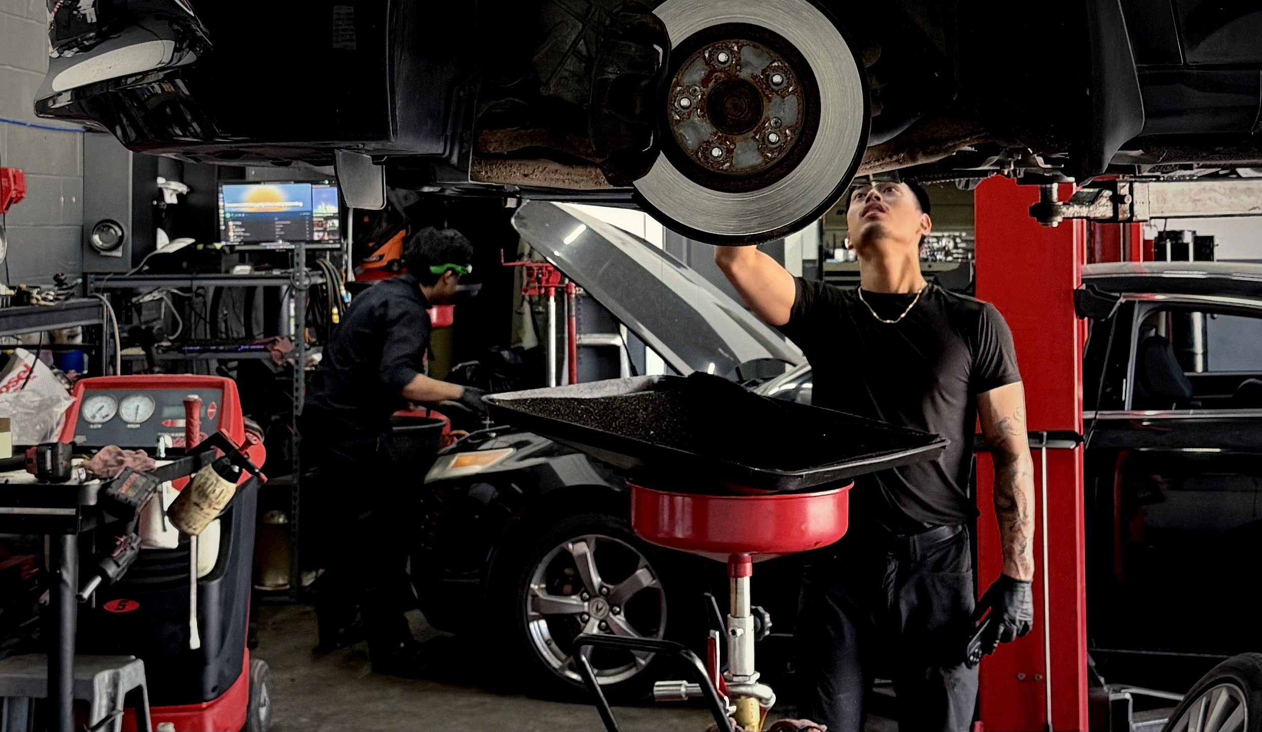 Roshie Automotive technicians servicing a vehicle in the Burnaby shop